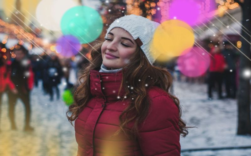 holiday bokeh overlays on an image of a woman