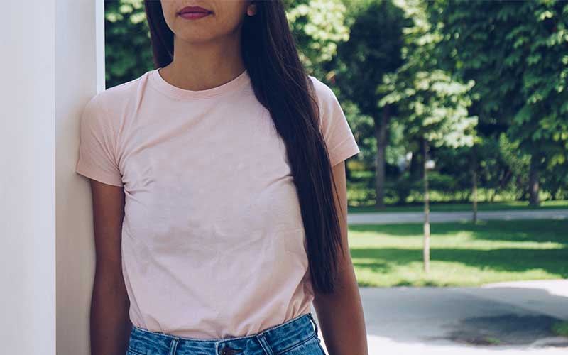 A preview of a woman wearing a plain peach t-shirt