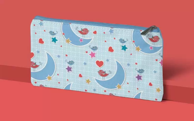 A preview of an animal pattern of colorful birds with moons and stars used on a small blue pouch