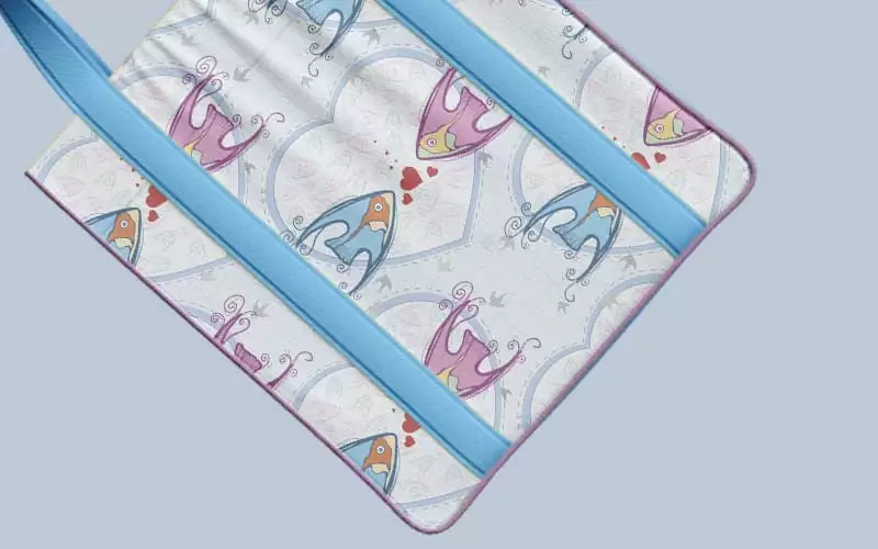 A preview of a design pattern having pink and blue fish on it  used on a hand bag